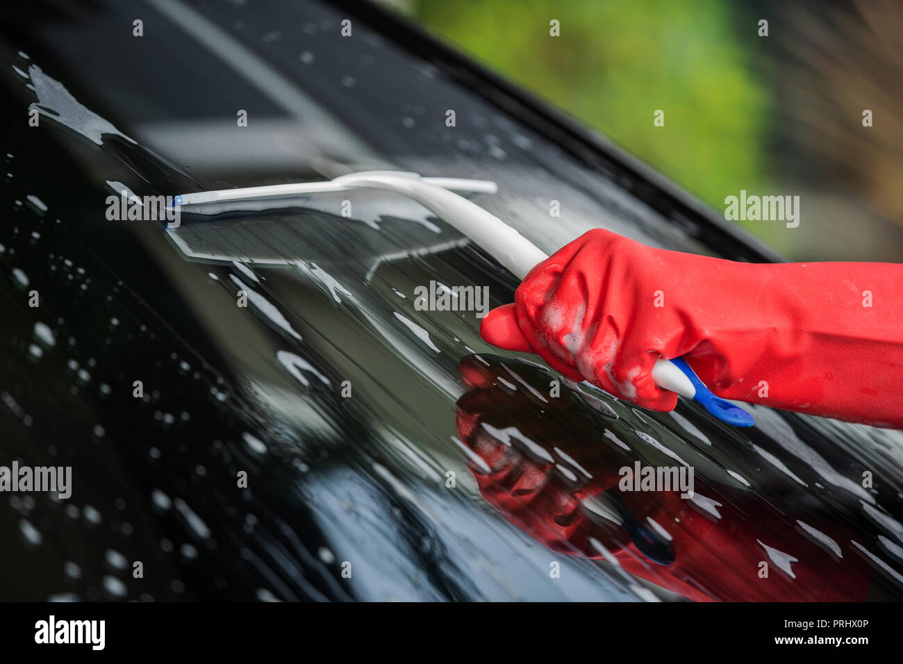 hand using squeegee to washing windshield of a car Stock Photo Alamy