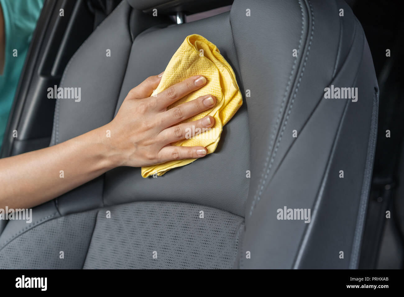 hand with yellow microfiber cloth cleaning leather seat Stock Photo Alamy