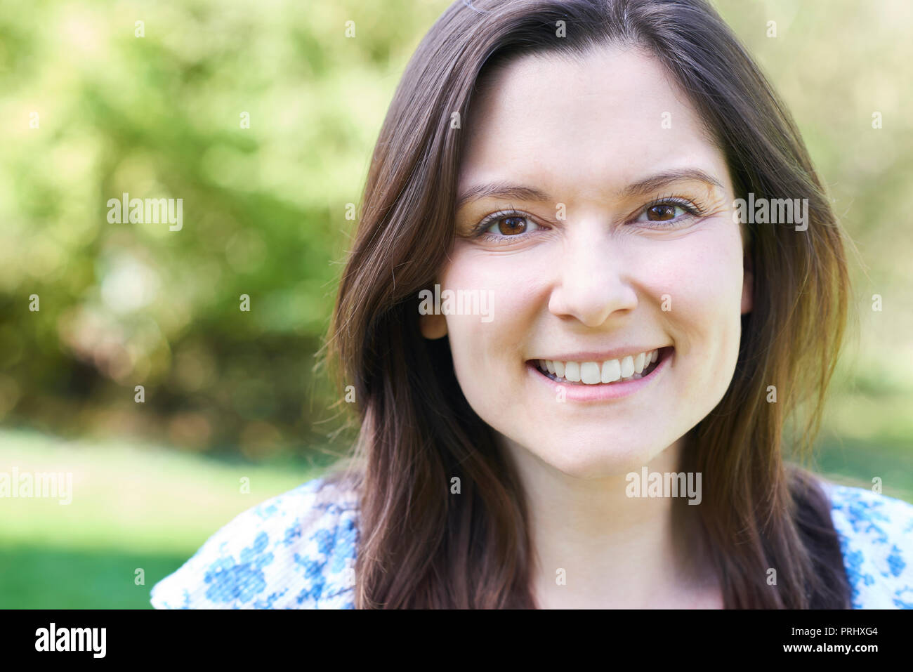 Outdoor Head And Shoulders Portrait Of Laughing Young Woman Stock Photo ...