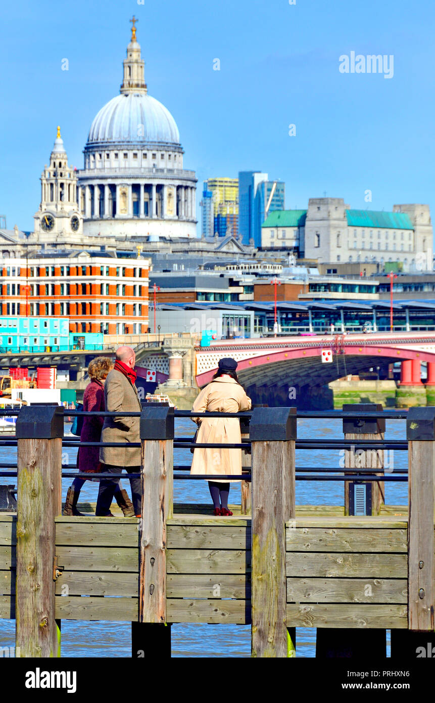 People looking towards St Paul's Cathedral from one of the wooden piers on Gabriel's Beach, South Bank, London, England, UK. Stock Photo