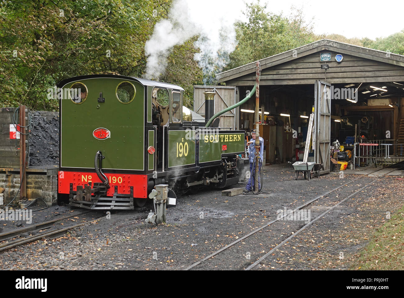 Visiting steam engine No 190 LYD (built at and owned by the Festiniog Railway) taking on water at the engine shed at Woody Bay station on the restored Stock Photo
