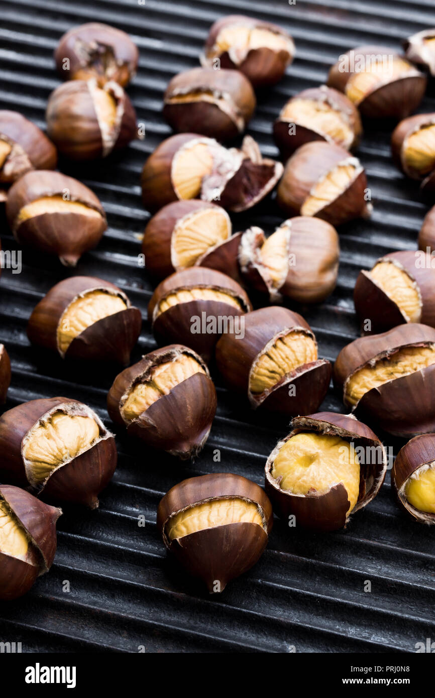 Roasted chestnuts in frying pan isolated on white Stock Photo Alamy