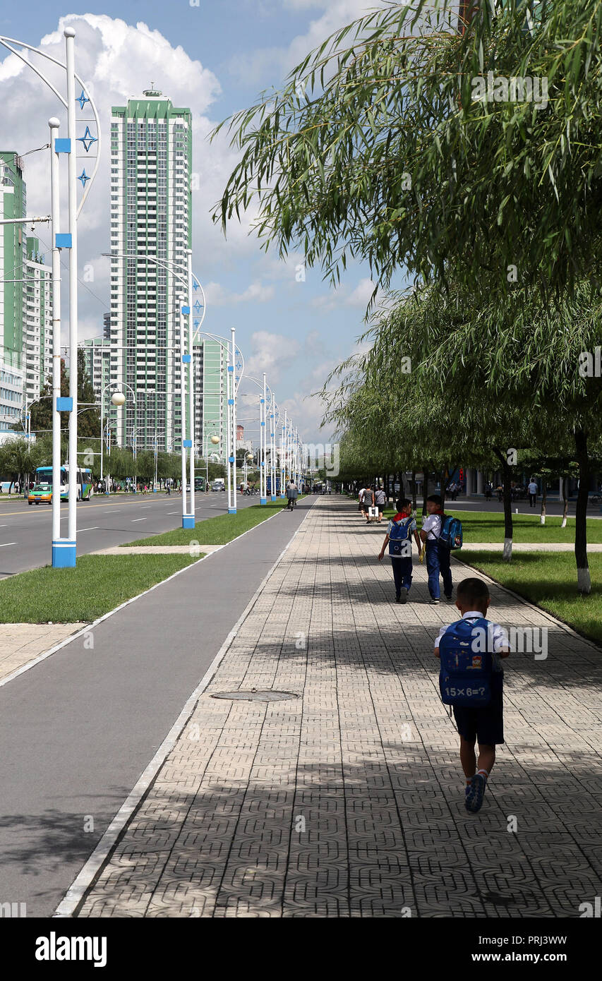 Schoolboys walking home along Mirae Scientists Street in Pyongyang Stock Photo