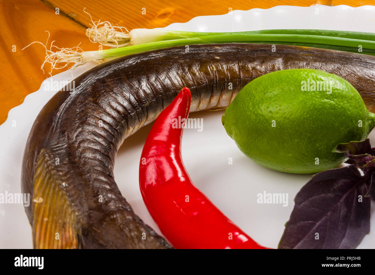 still life - Garfish, billfish raw and fresh, top view, with onions, lemon, prepared for cooking Stock Photo