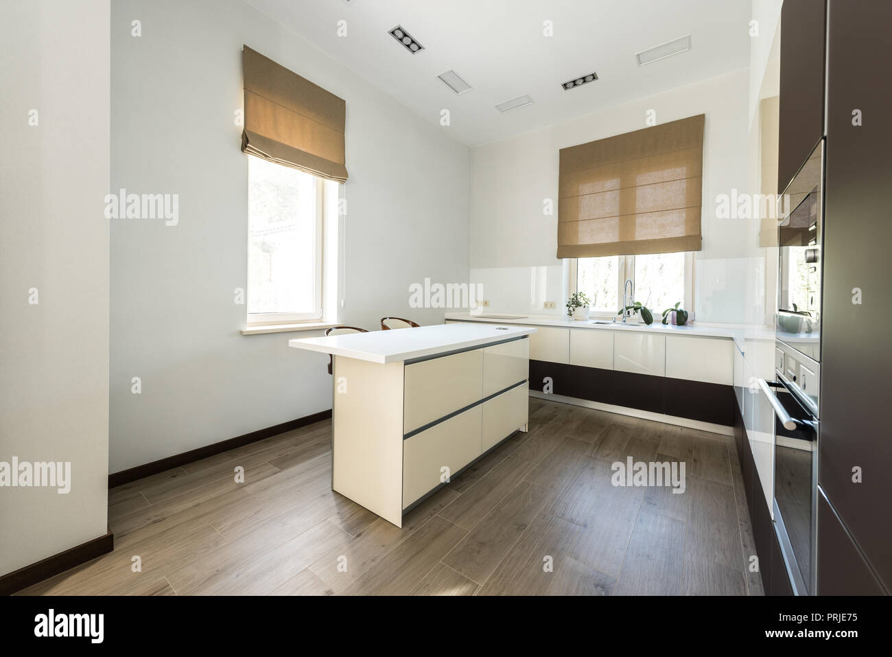 interior view of empty modern kitchen with furniture in light colors Stock Photo
