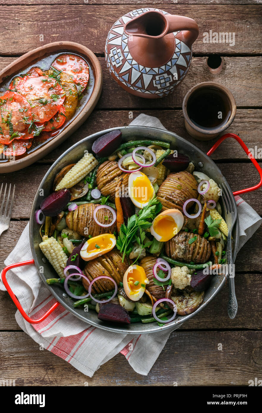 Baked root vegetables in a pan, rustic style Stock Photo