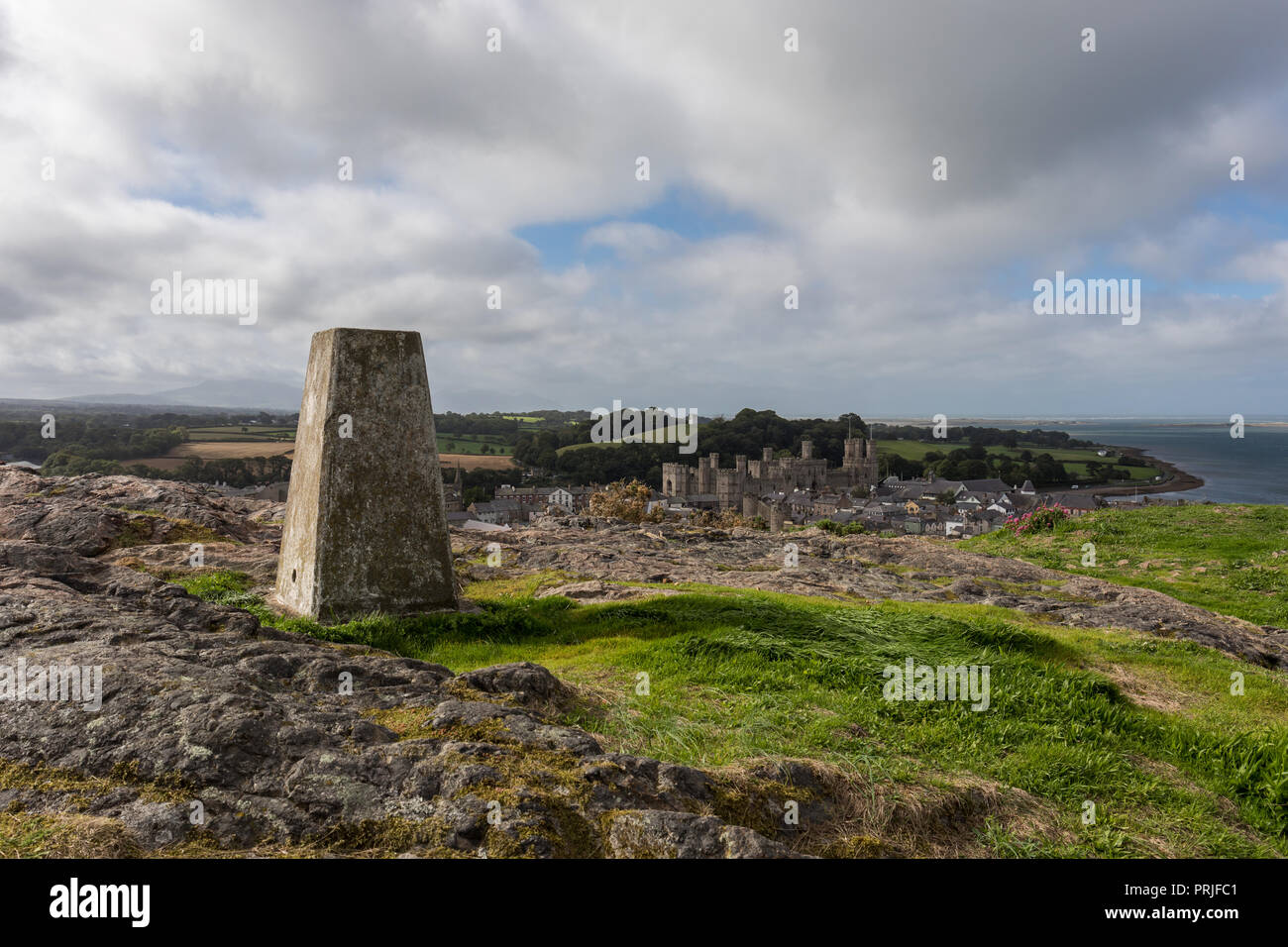 Twthill trigpoint and Caernarfon town, Gwynedd, North Wales, UK Stock