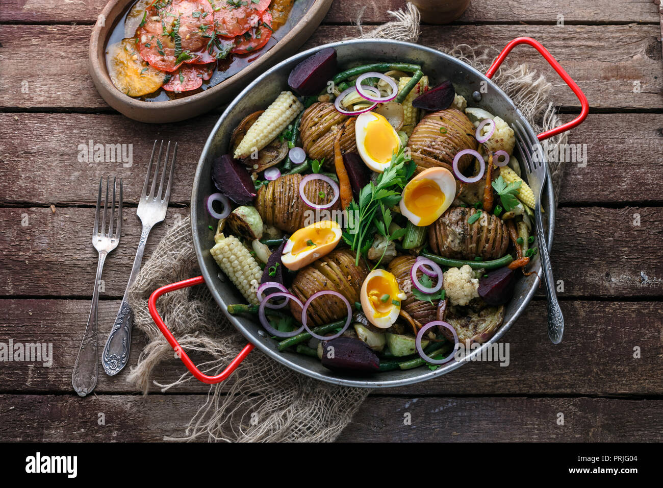 Baked potatoes, carrots, green beans and eggs. Stock Photo