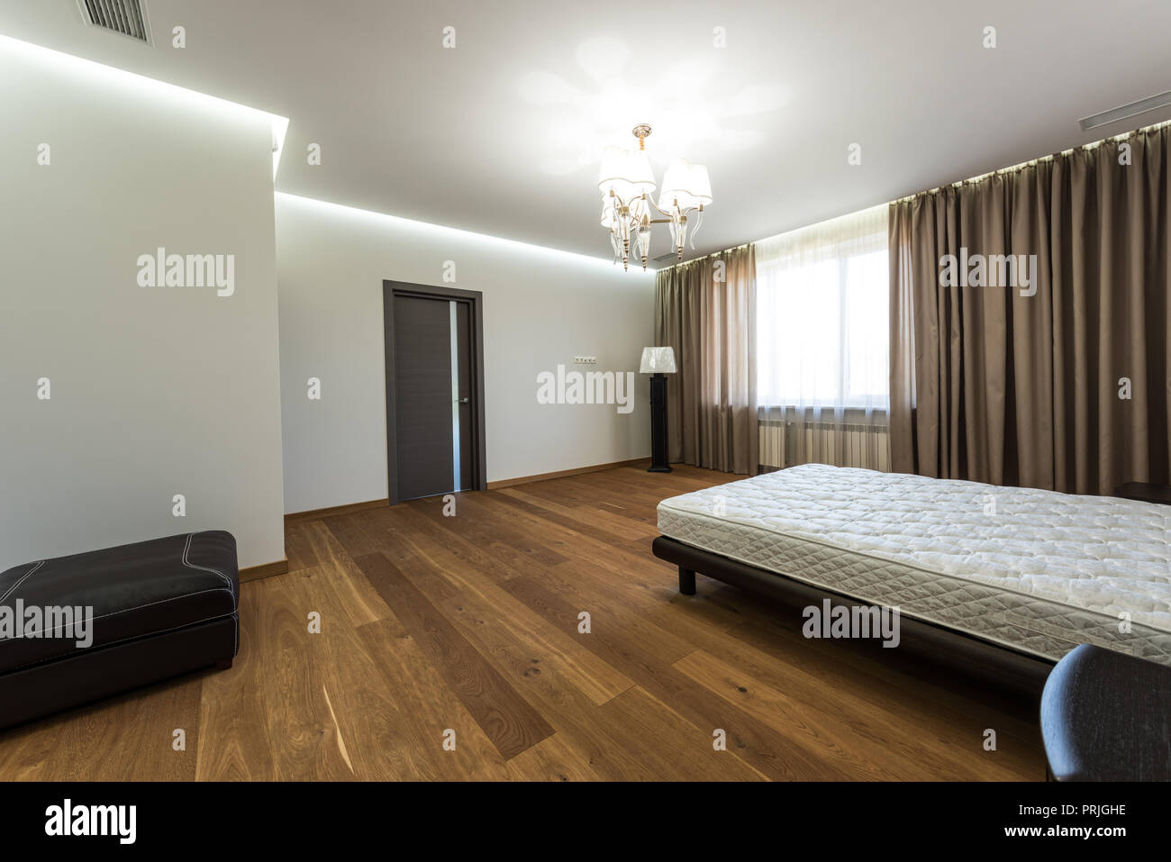 interior of modern bedroom with big window and mattress on bed Stock Photo