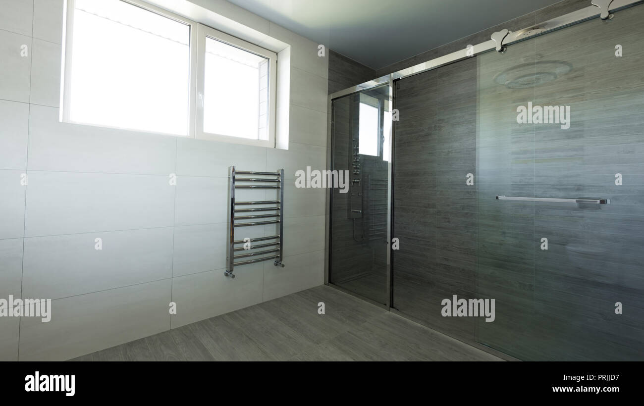 interior of empty bathroom with glass shower in grey color Stock Photo