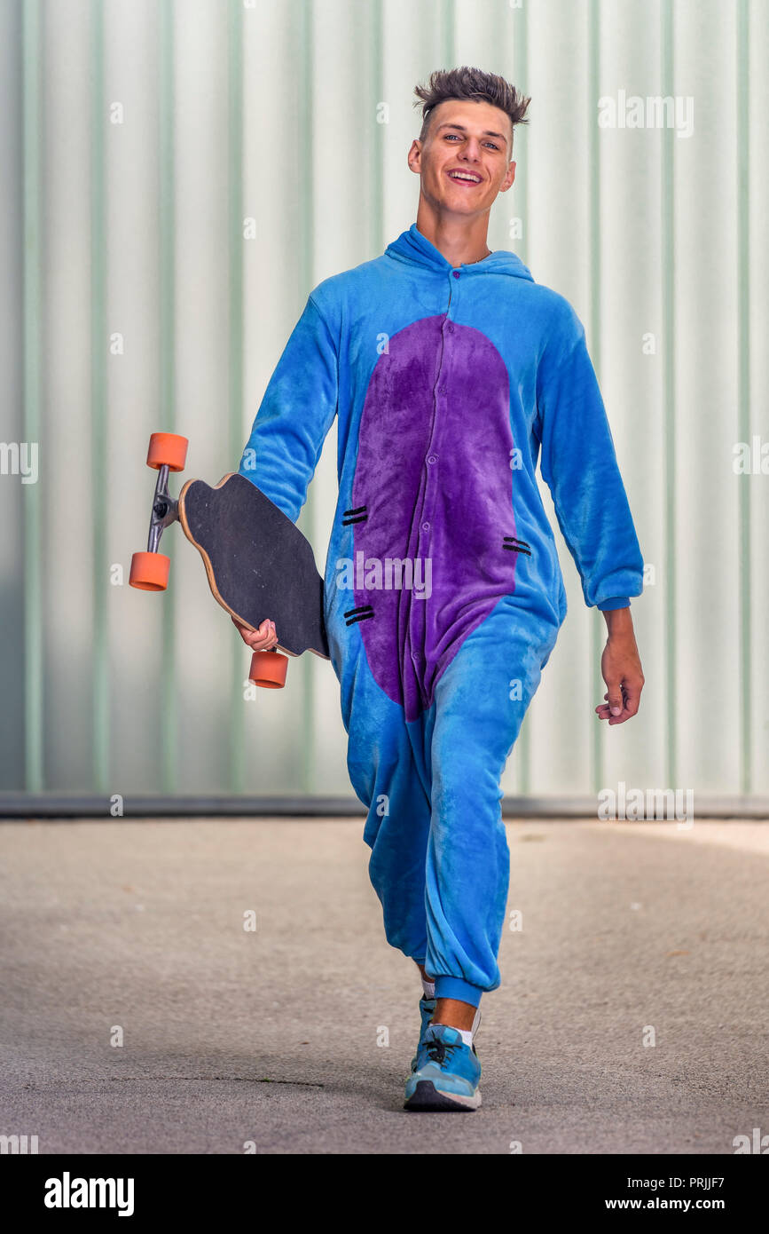 Teenager, 17 years, wearing a onepiece with longboard, Germany Stock Photo