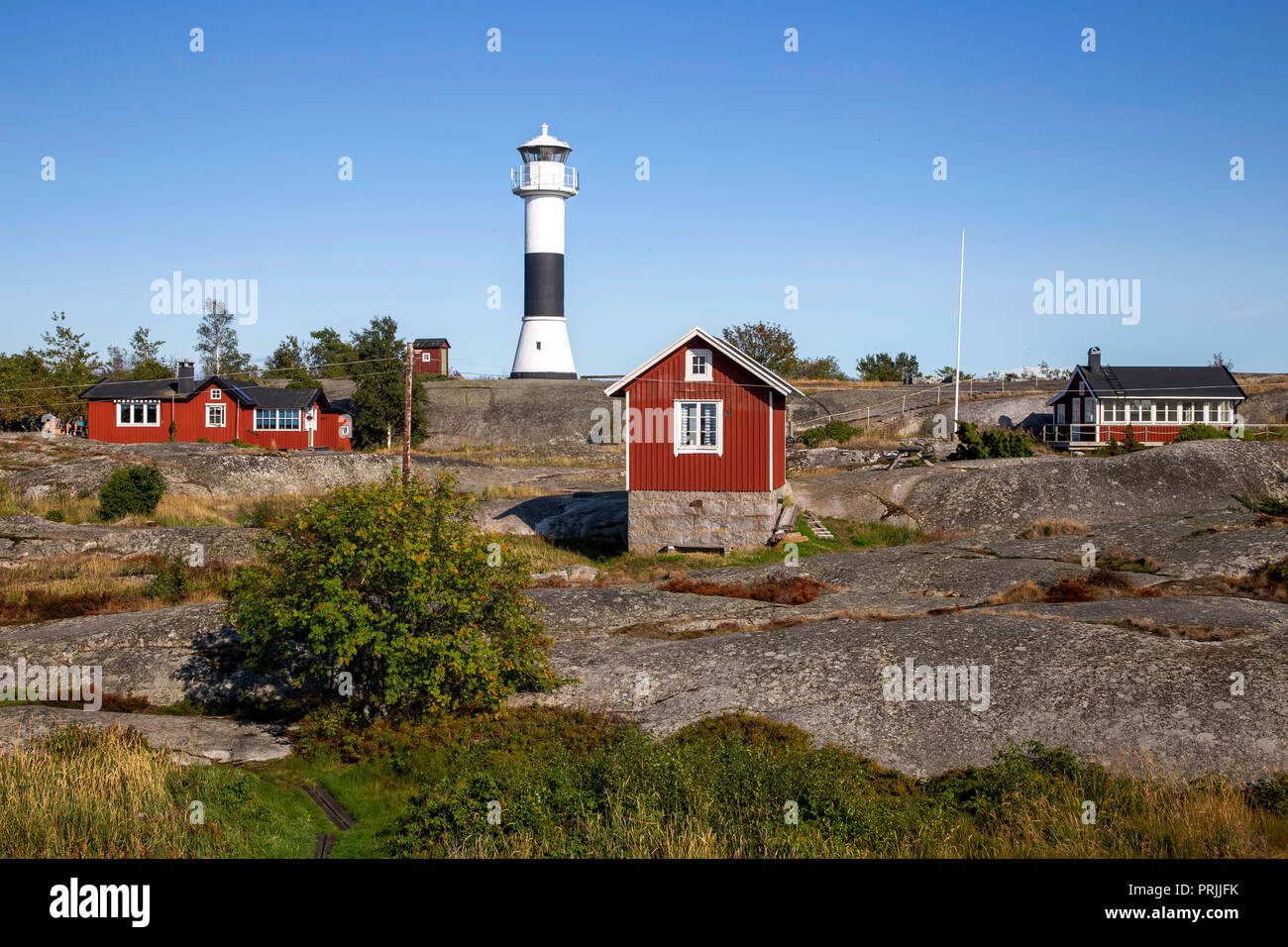 Red wooden houses with lighthouse, Stockholm archipelago, Huvudskär archipelago island, Sweden Stock Photo