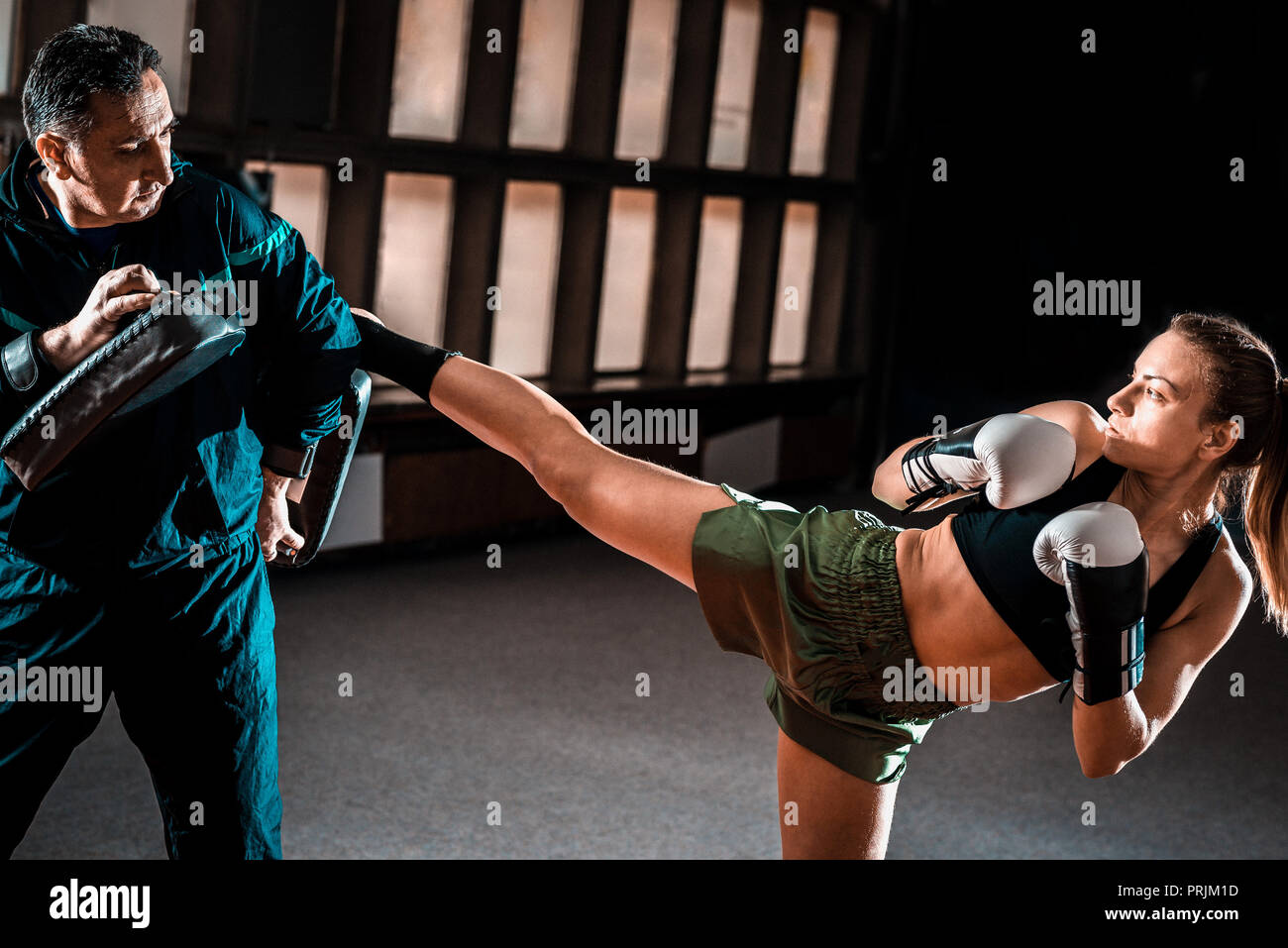 Young adult woman doing high kick during kickboxing training exercise Stock Photo Alamy