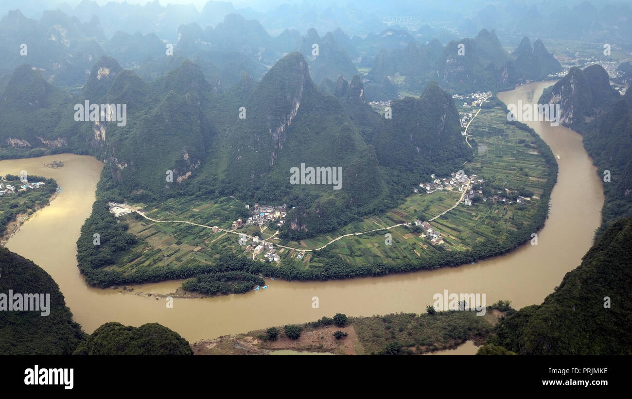 aerial view of village and river between green hills in Indonesia Stock Photo