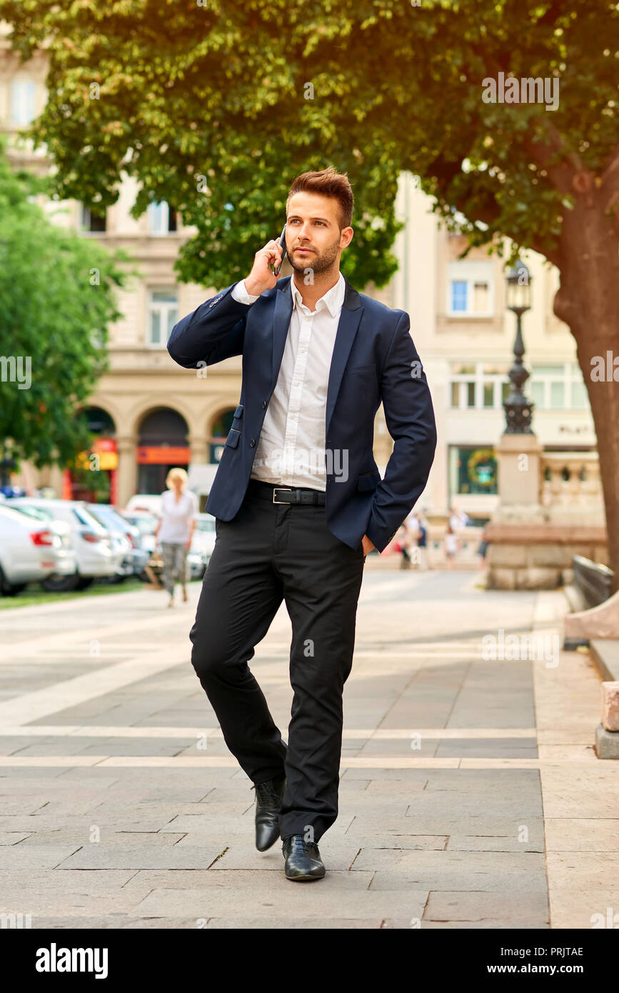 Stylish businessman in suit on sunny city street hi-res stock ...