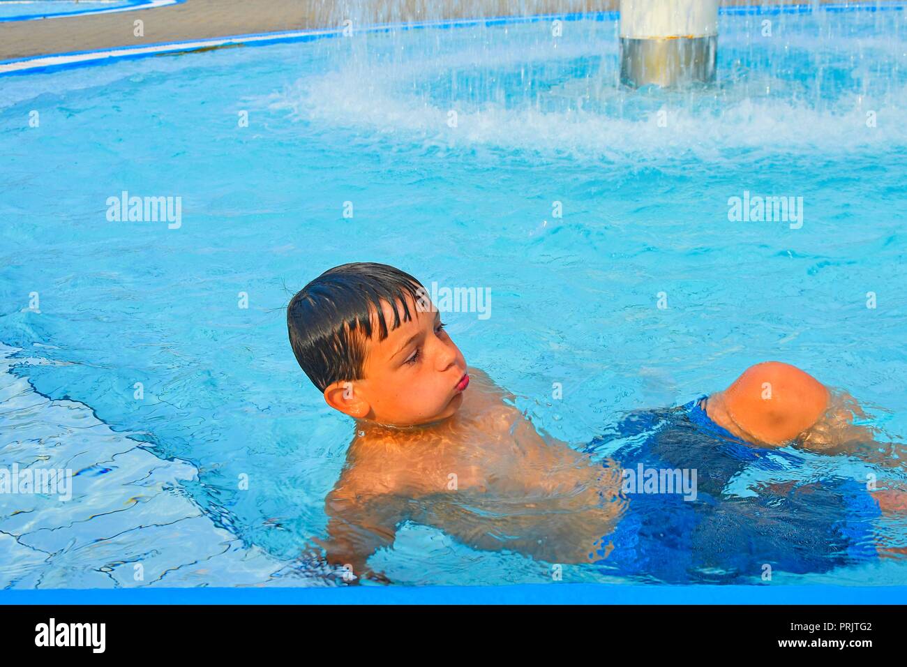 Summertime And Swimming Activities For Happy Children In The Pool Cute Boy In Water Park