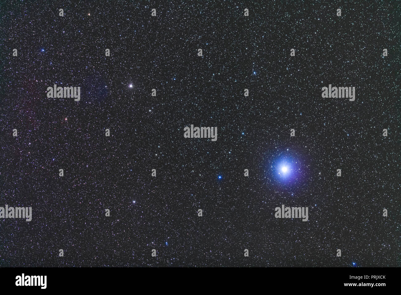 Canopus, the second brightest star in the night sky. The star at left is Tau Puppis. The Carina Dwarf Galaxy is between the two stars but invisible he Stock Photo