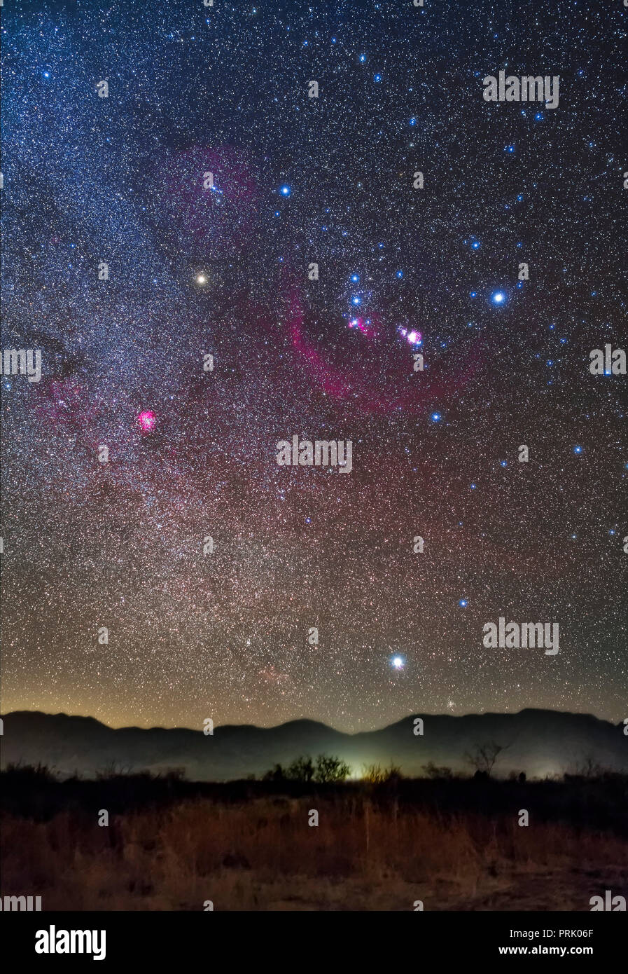 Orion and Sirius rising over the Peloncillo Mountains of southwest New Mexico, on a clear night in December in the early evening. The Belt stars of Or Stock Photo