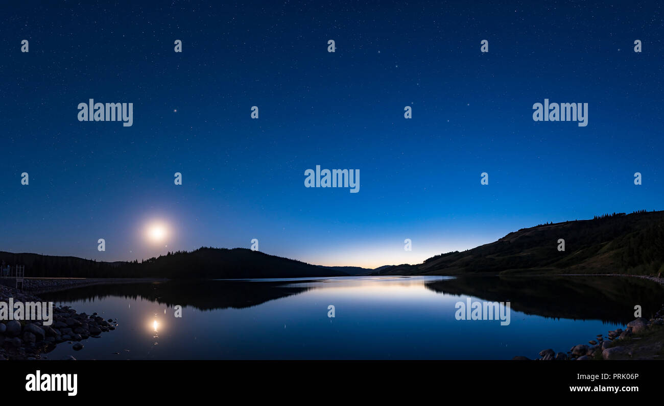A panorama of the western sky in deep twilight at Reesor Lake in the Cypress Hills of southeast Alberta, in the Cypress Hills Interprovincial Park, a  Stock Photo