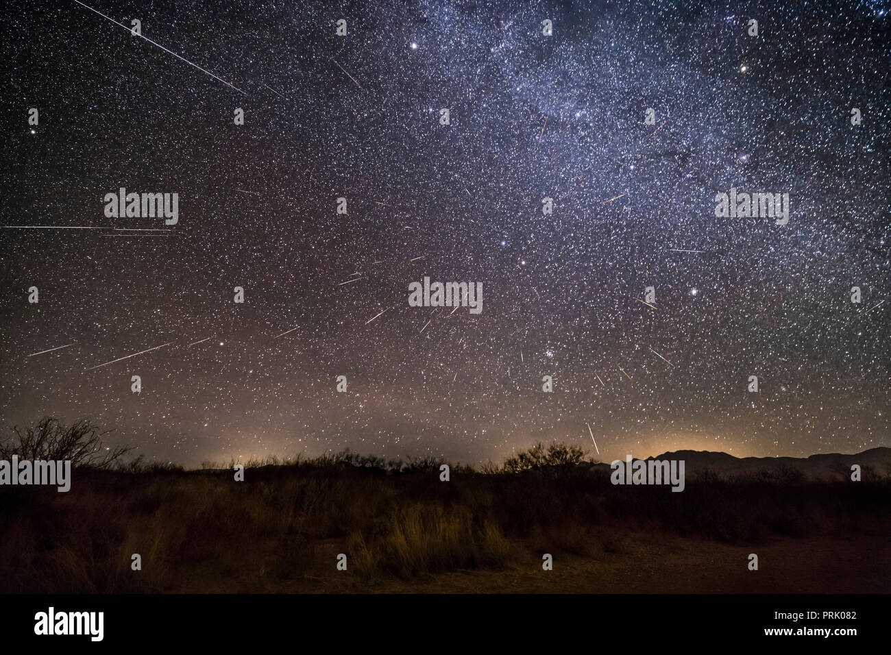 A composite of the 2017 Geminid meteor shower, from the peak night of December 13, with the radiant in Gemini, at centre, rising in the northeast at t Stock Photo