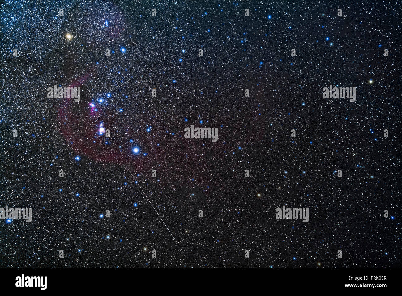 The constellations of Orion the hunter and Eridanus the river (at right), with the bonus of a Geminid meteor below Orion, through Lepus the hare.   Th Stock Photo