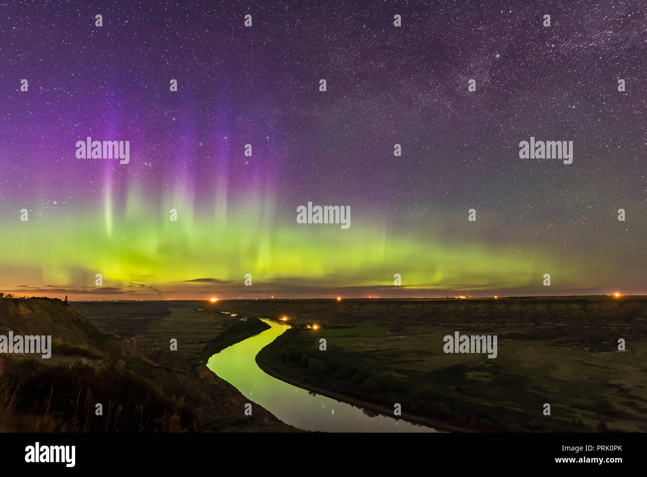 The Northern Lights dance over the sweeping Red Deer River and Badlands of southern Alberta, from Orkney Viewpoint looking north over the valley. The  Stock Photo