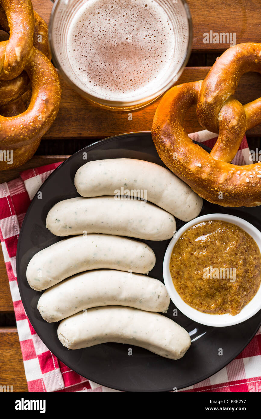 The bavarian weisswurst, pretzel and mustard. Top view. Stock Photo