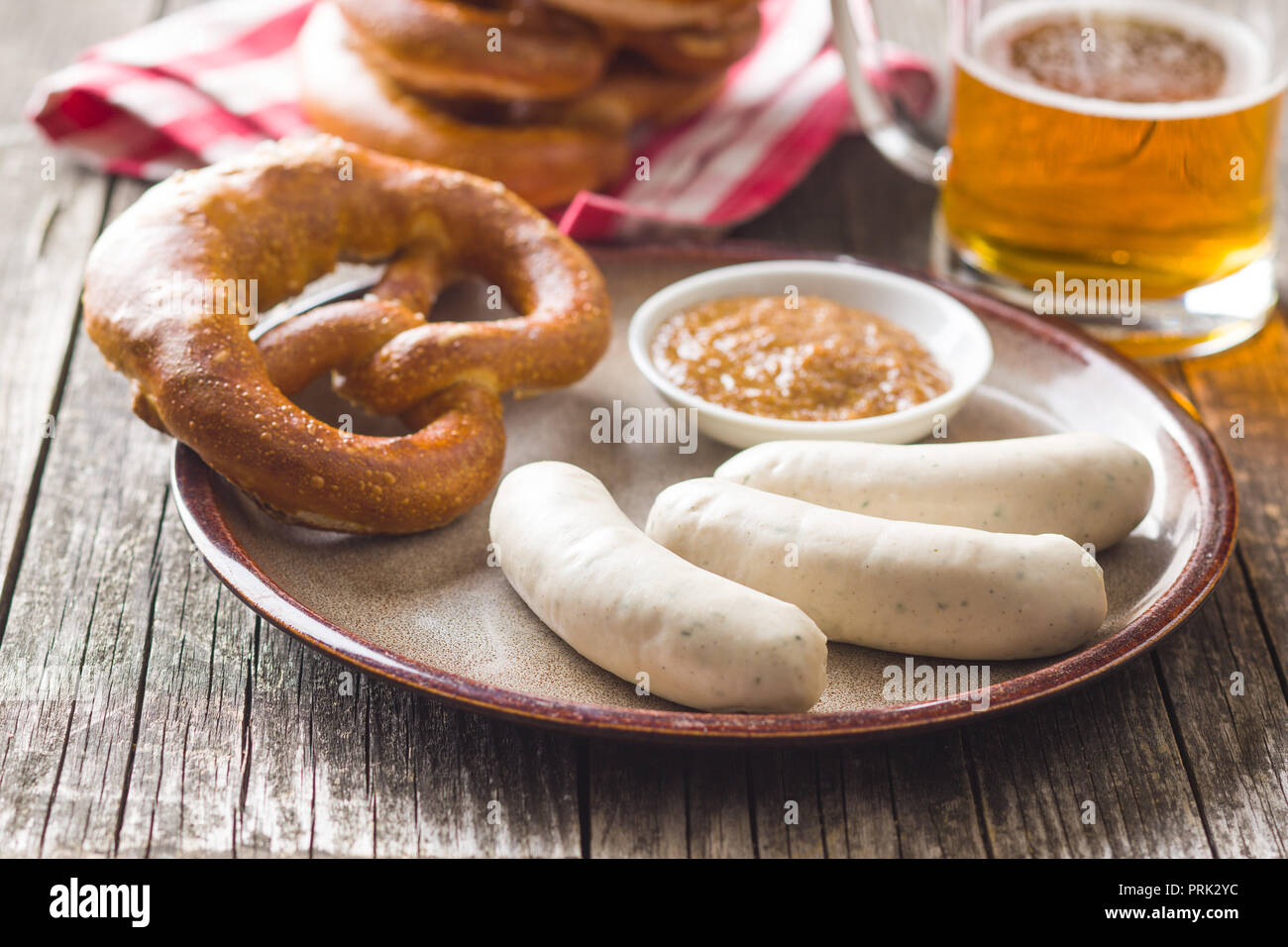 The bavarian weisswurst, pretzel and mustard on plate. Stock Photo
