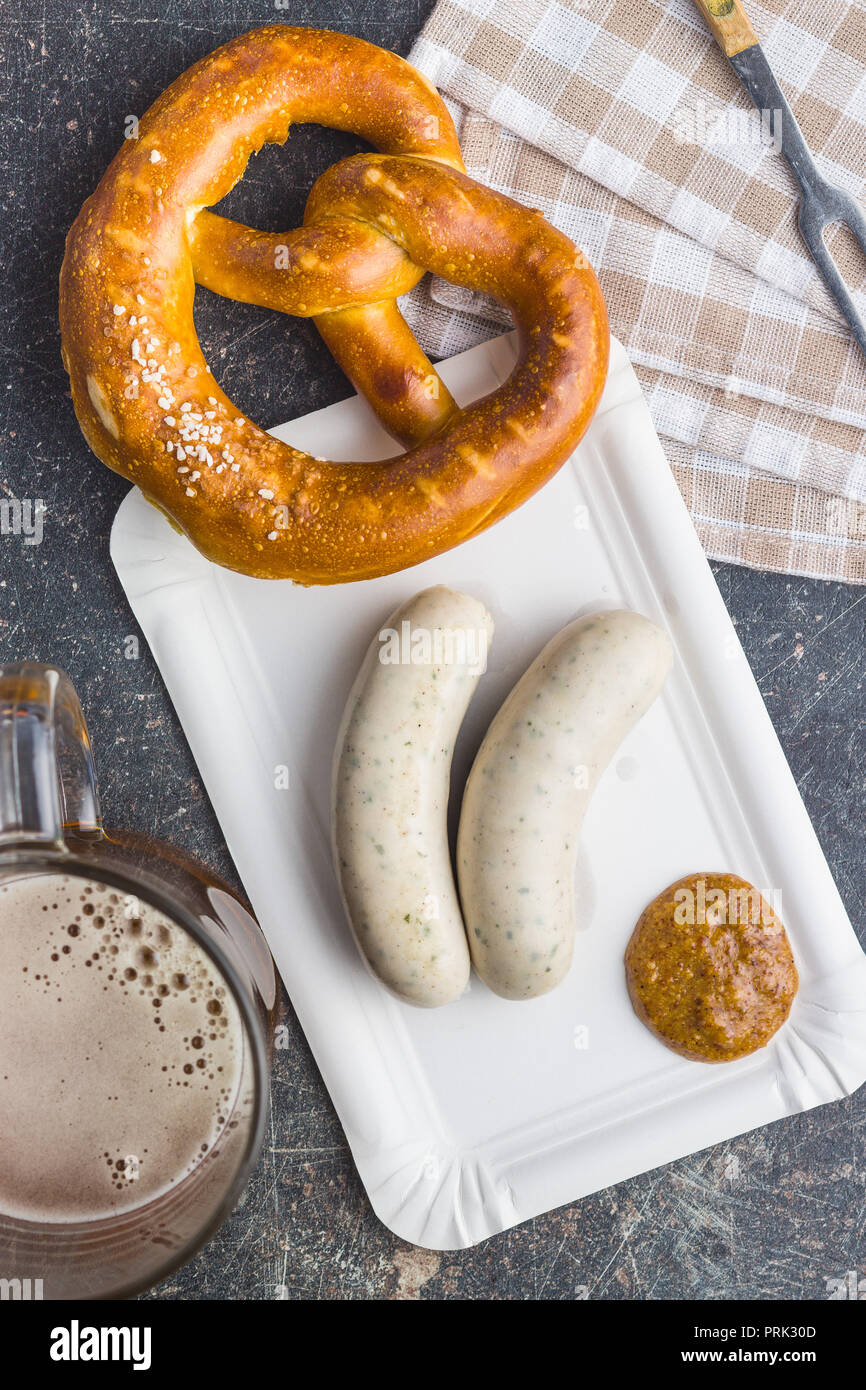 The bavarian weisswurst, pretzel and mustard on paper plate. Stock Photo