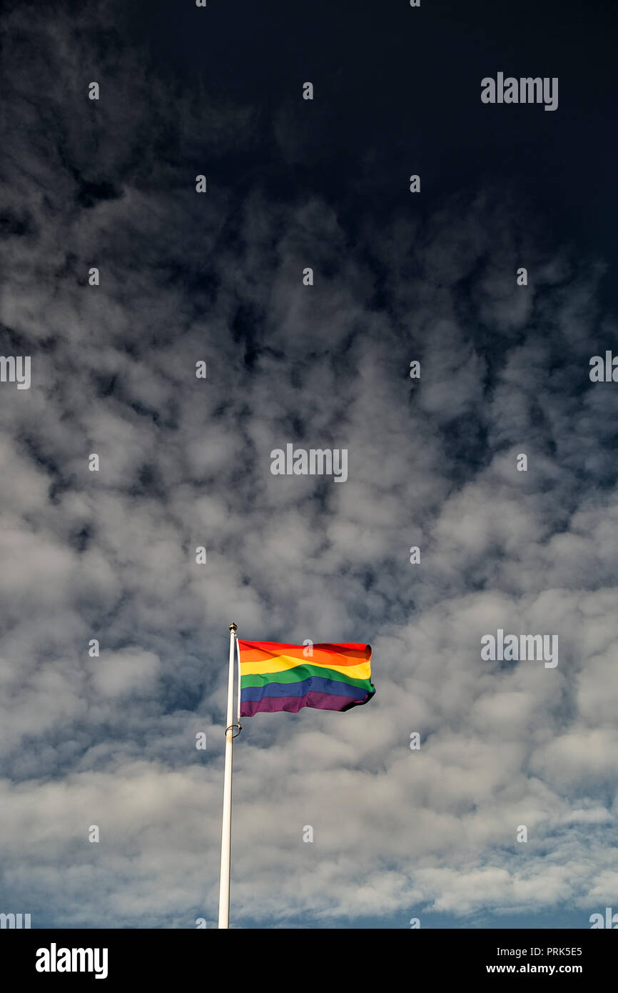 Rainbow Flag waving in the wind with a partly cloudy sky Stock Photo ...