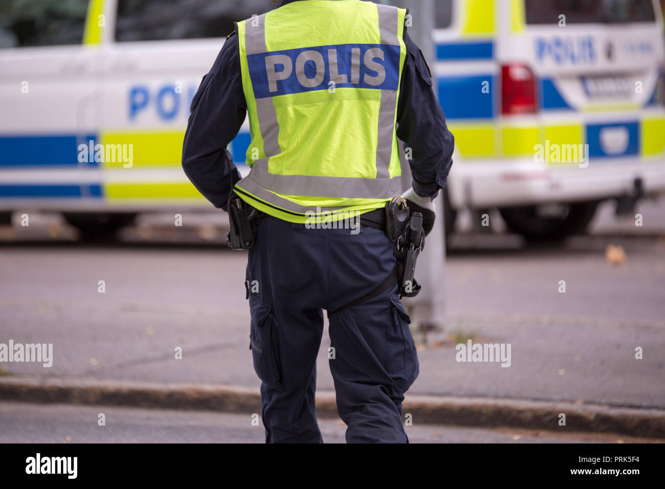 Swedish Police Officer with Reflective Vest and gun Stock Photo - Alamy