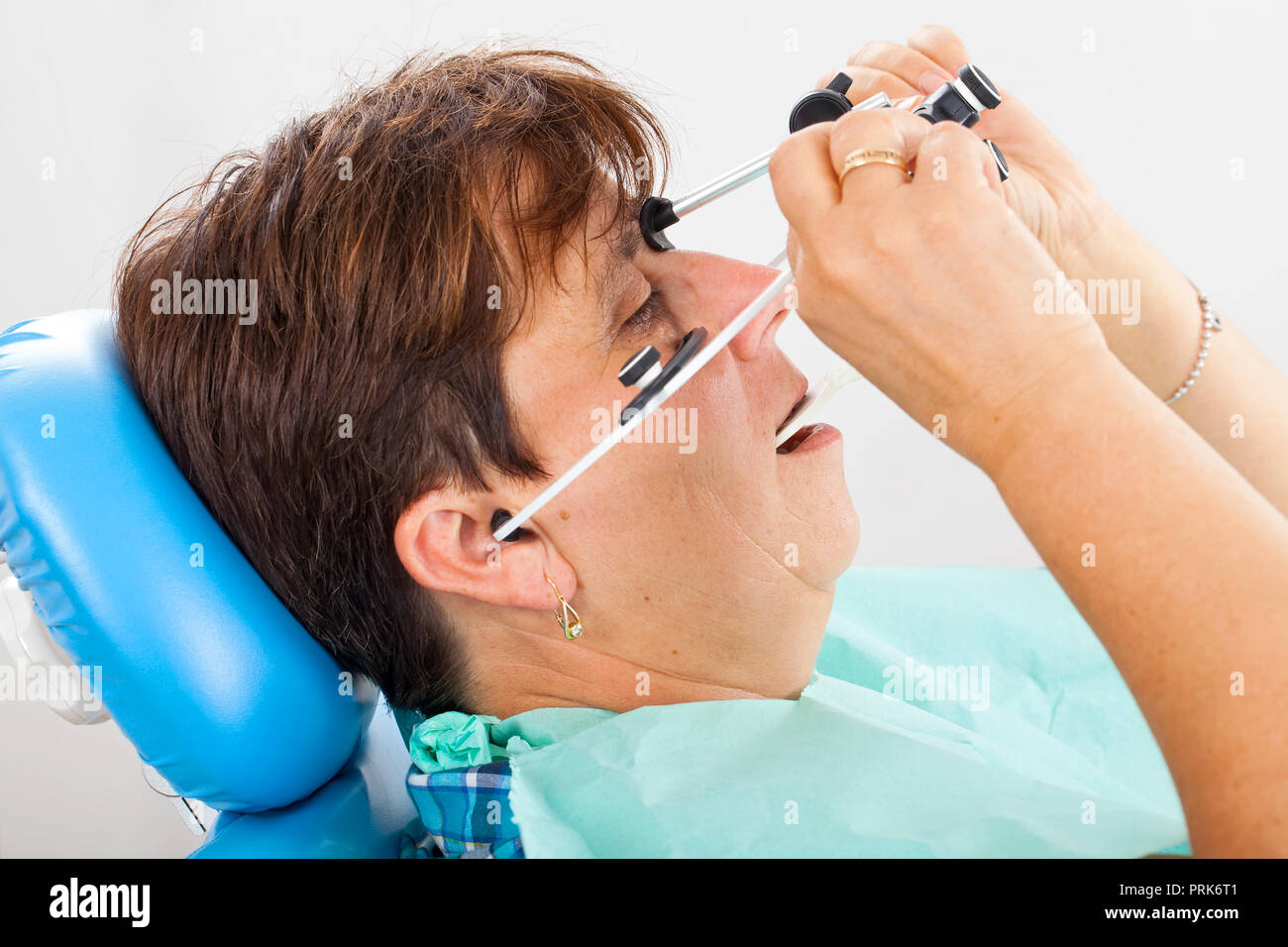 Seniorpatient wearing a facebow for transfer functional and aesthetic