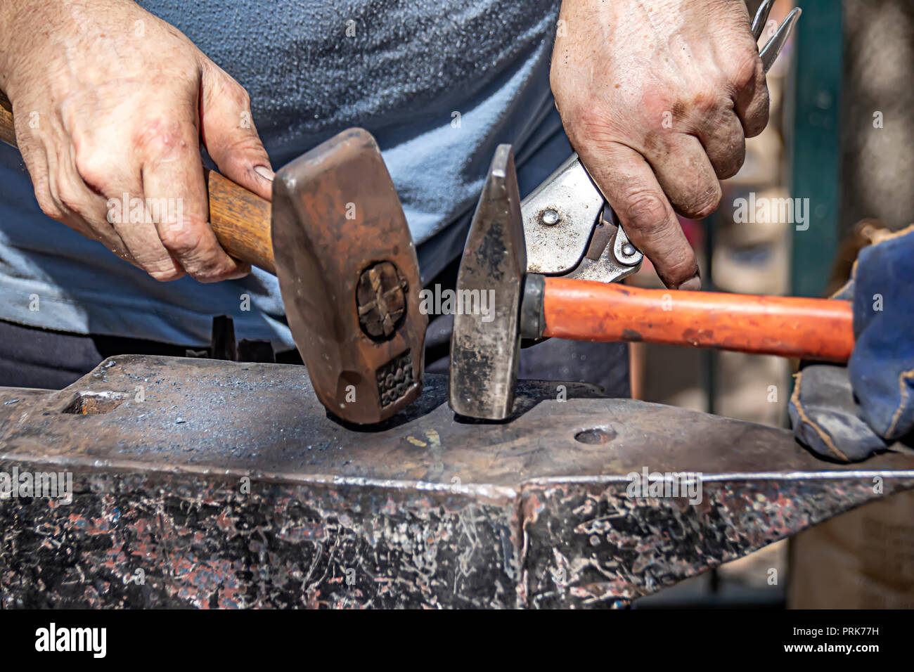 The hands of blacksmiths with hammers Stock Photo