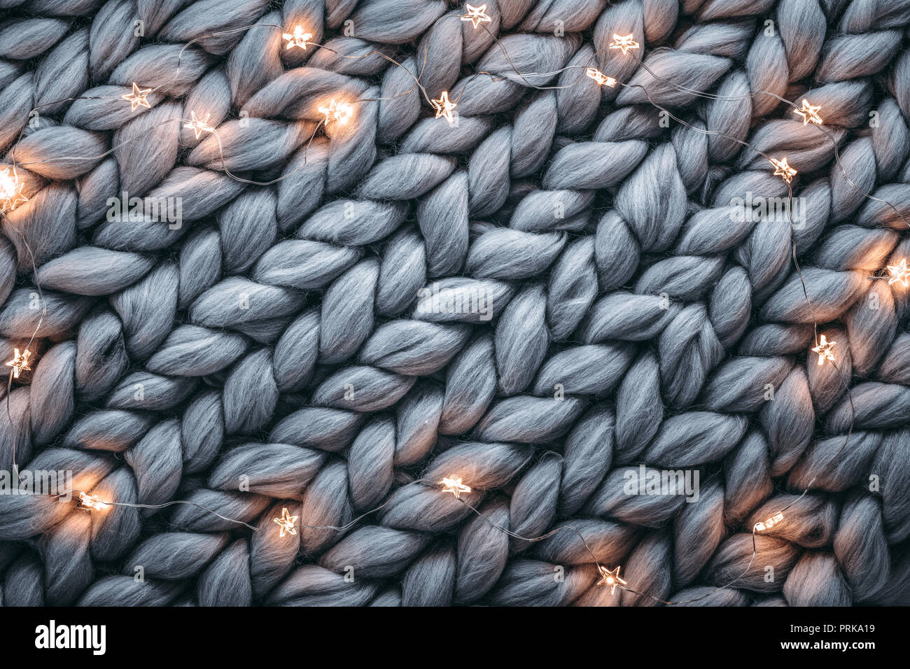 Christmas lights on warm woolen sweater,Closeup Stock Photo