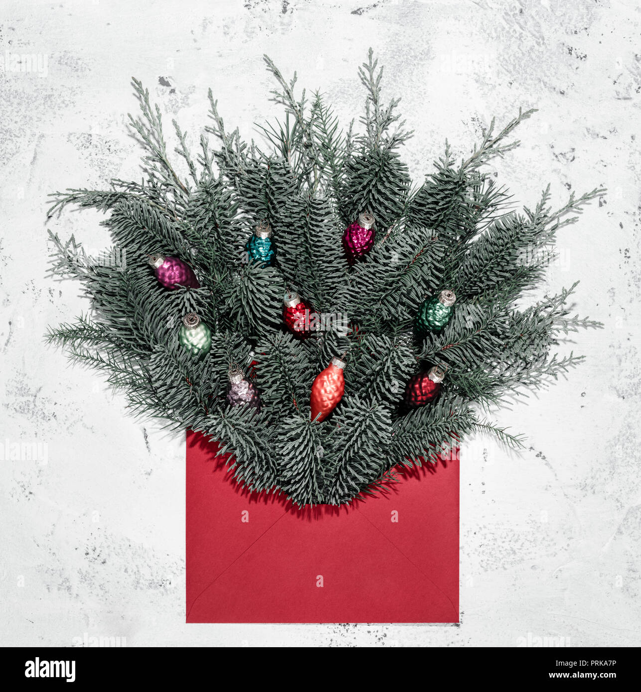 Minimalistic Christmas card mockup with fir branch,bulb, envelope Stock Photo