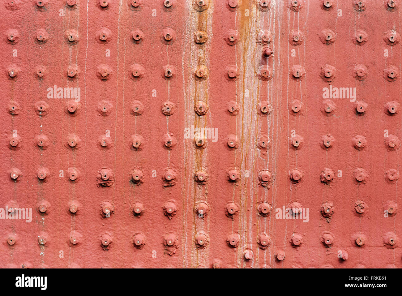 Backgrounds and textures: old painted metal wall surface with riveted joints, industrial abstract Stock Photo