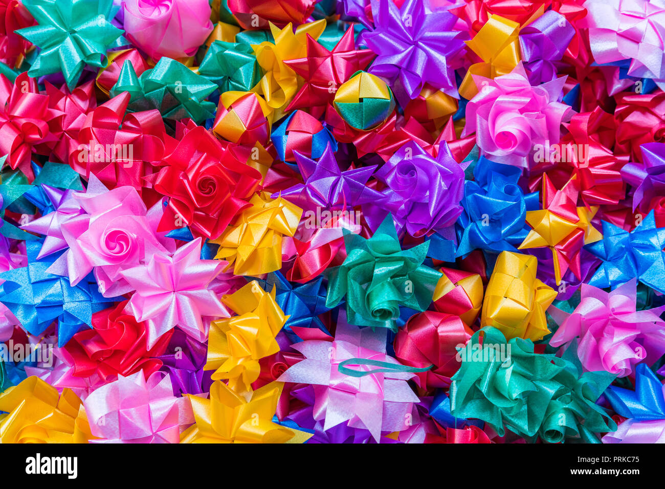 Colorful ribbon flowers for giving alms to make merit in Thai's ...