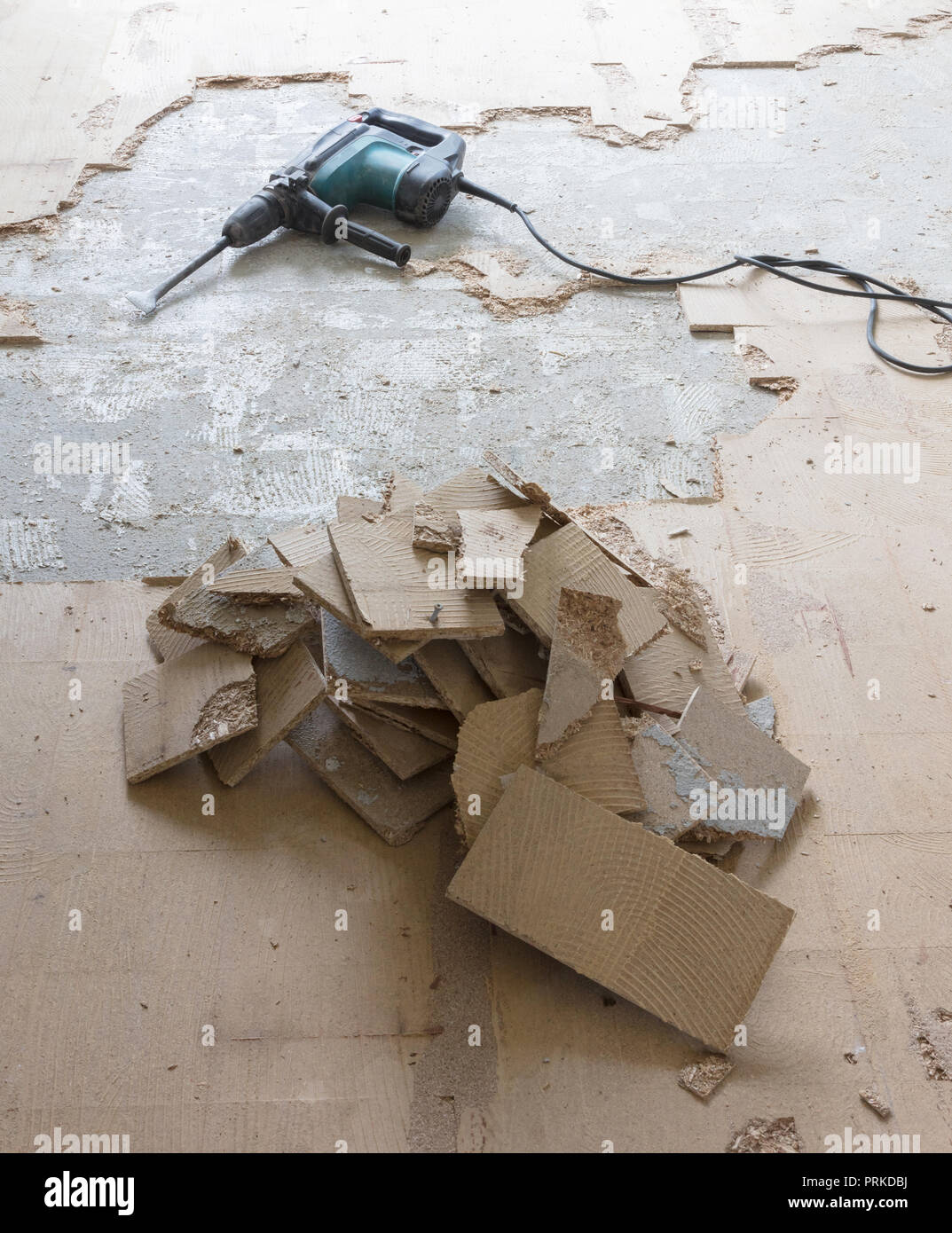 Construction concept Jackhammer, removing chipboard from the floor