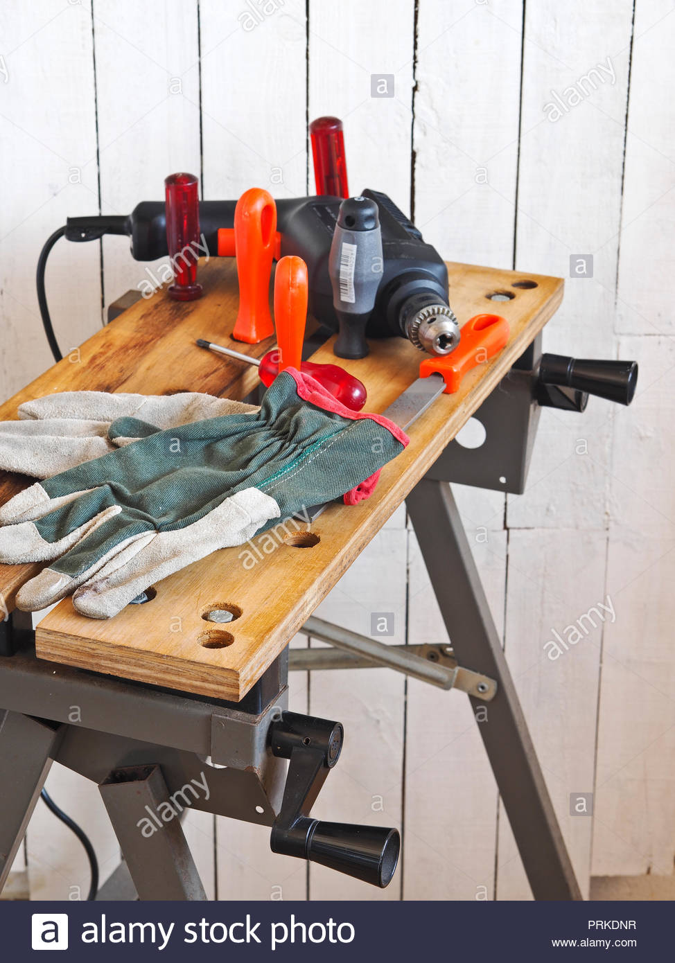 Electric Drill With Assorted Accessories And Tools And Work Gloves