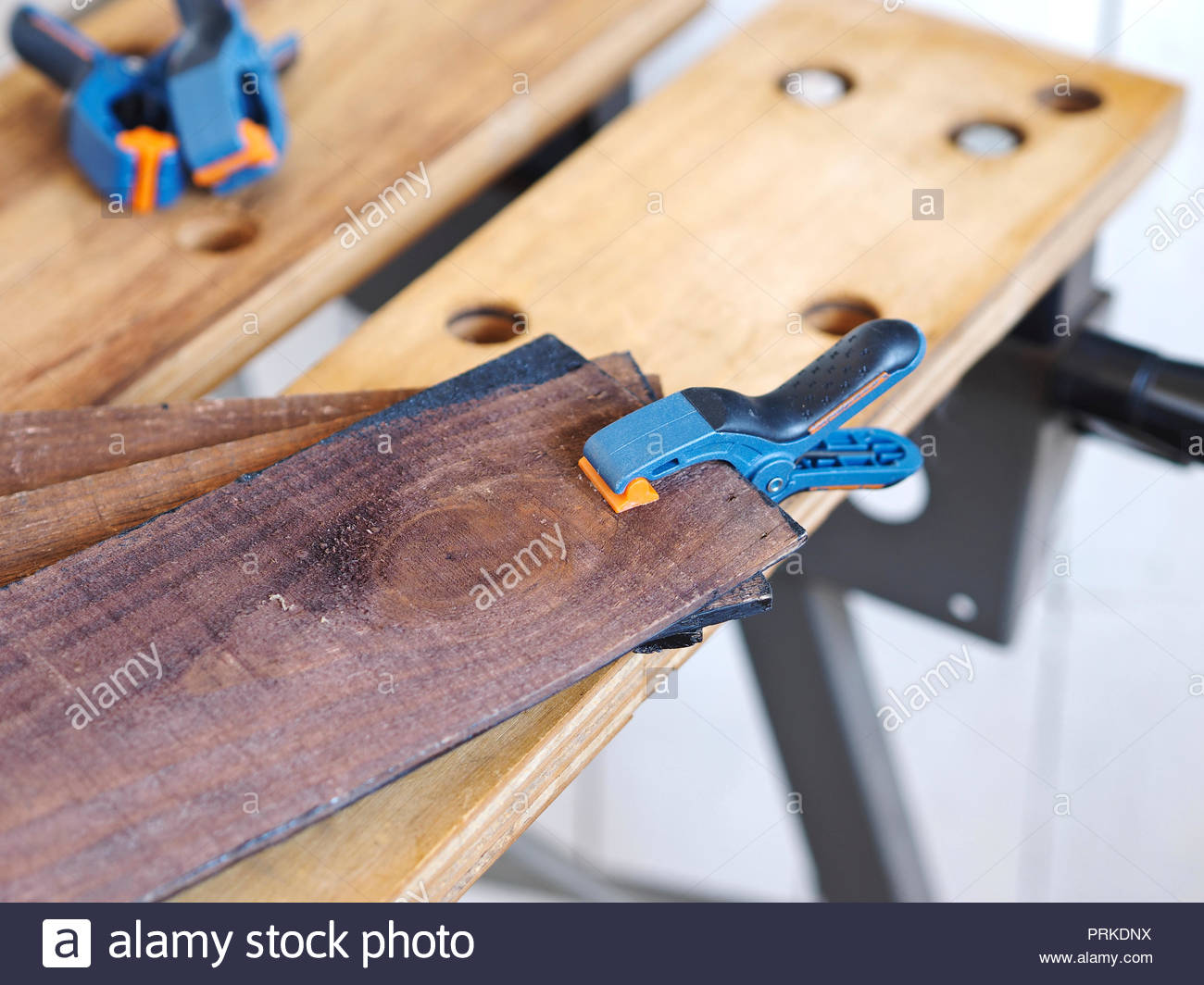 Gluing Pieces Of Wood Together On Work Bench With Spring Clamps