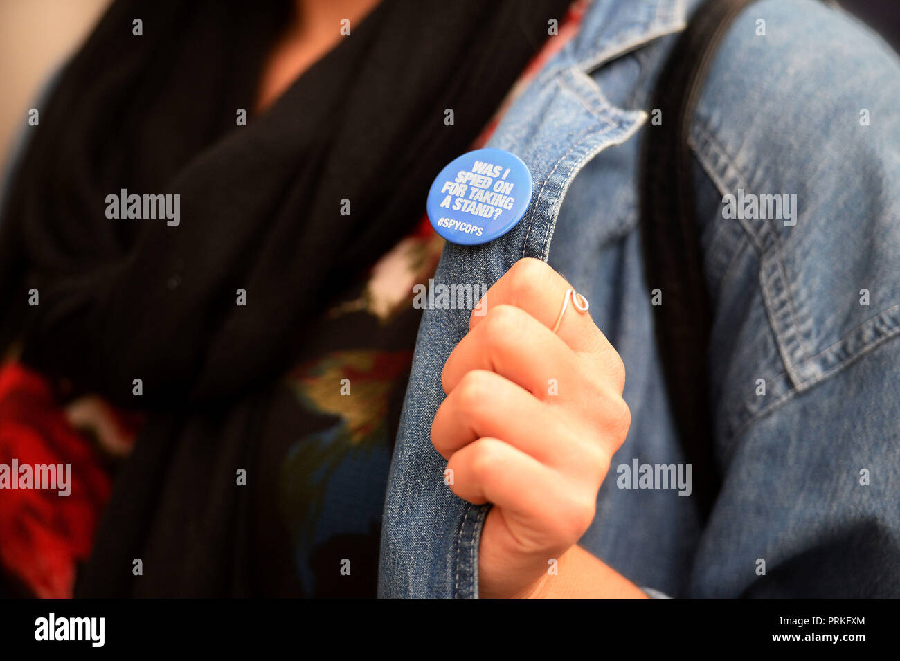 Detail of a badge worn by a demonstrator outside the Royal Courts of Justice, London, where an Investigatory Powers Tribunal is hearing the case of Kate Wilson who was deceived into a relationship by undercover police officer Mark Kennedy. Stock Photo