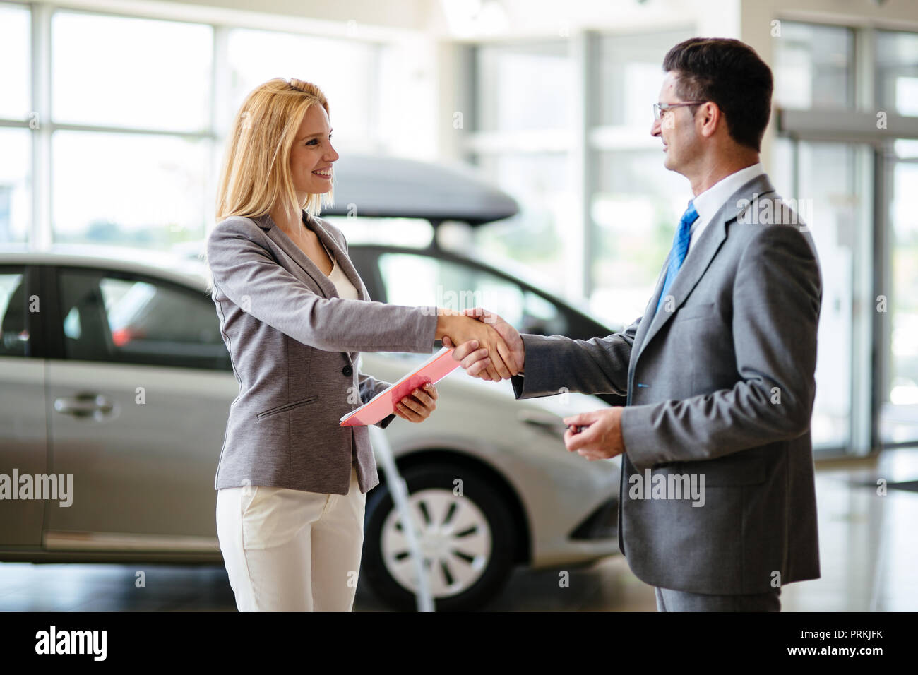 Successful businessman in a car dealership sale of vehicles to