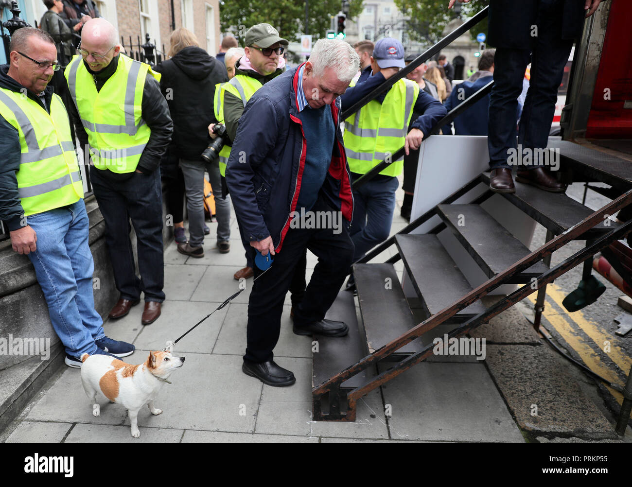 Fr Peter McVerry arrives with his dog Tiny during a Raise the Roof housing rights protest outside Leinster House in Dublin. Stock Photo