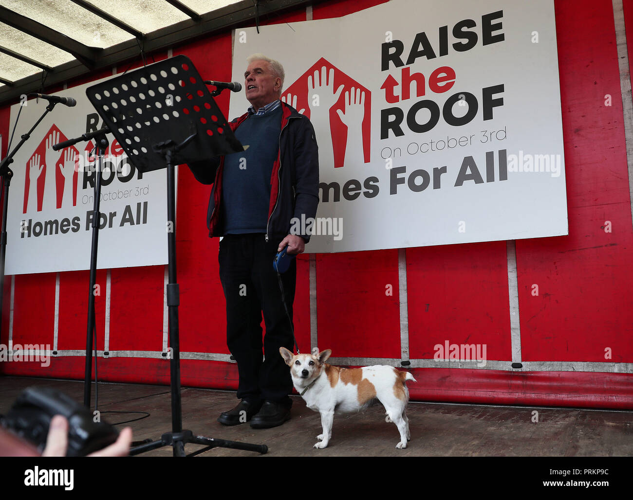 Fr Peter McVerry with his dog Tiny speaking during a Raise the Roof housing rights protest outside Leinster House in Dublin. Stock Photo
