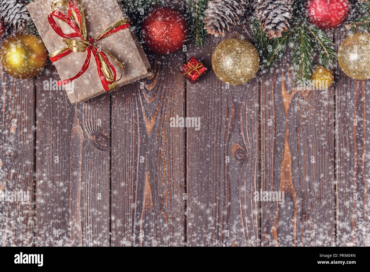 Christmas gift boxes and fir tree on wooden background. Top view with ...