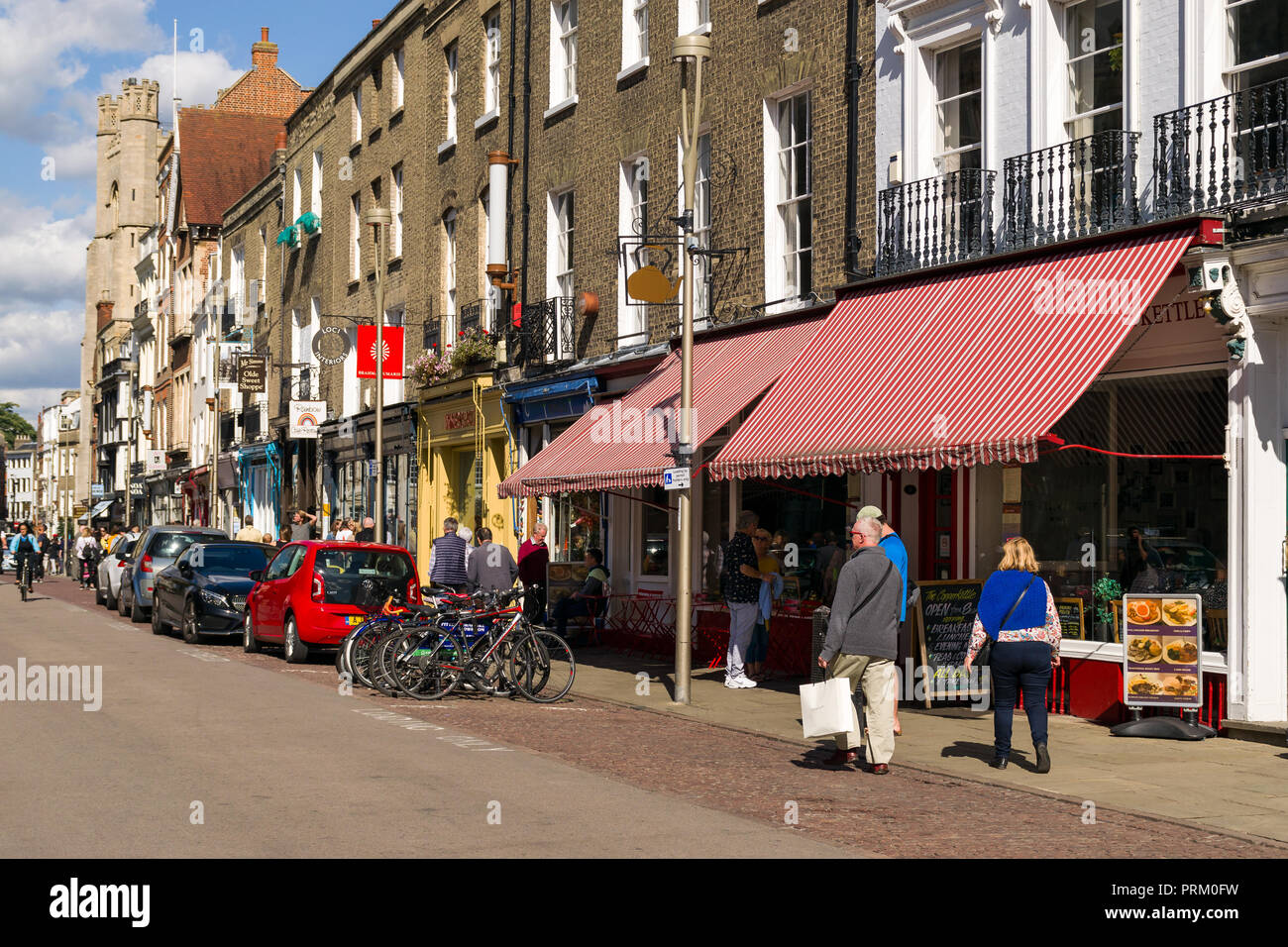 View of Kings Parade with shops, buildings and people walking past on a sunny Summer day, Cambridge, UK Stock Photo