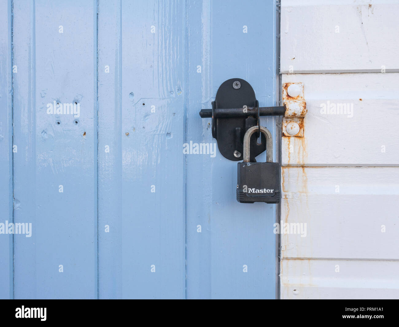 Padlocked door of a beach hut at Newquay, Cornwall. Locked in place, lock in place metaphor. Stock Photo