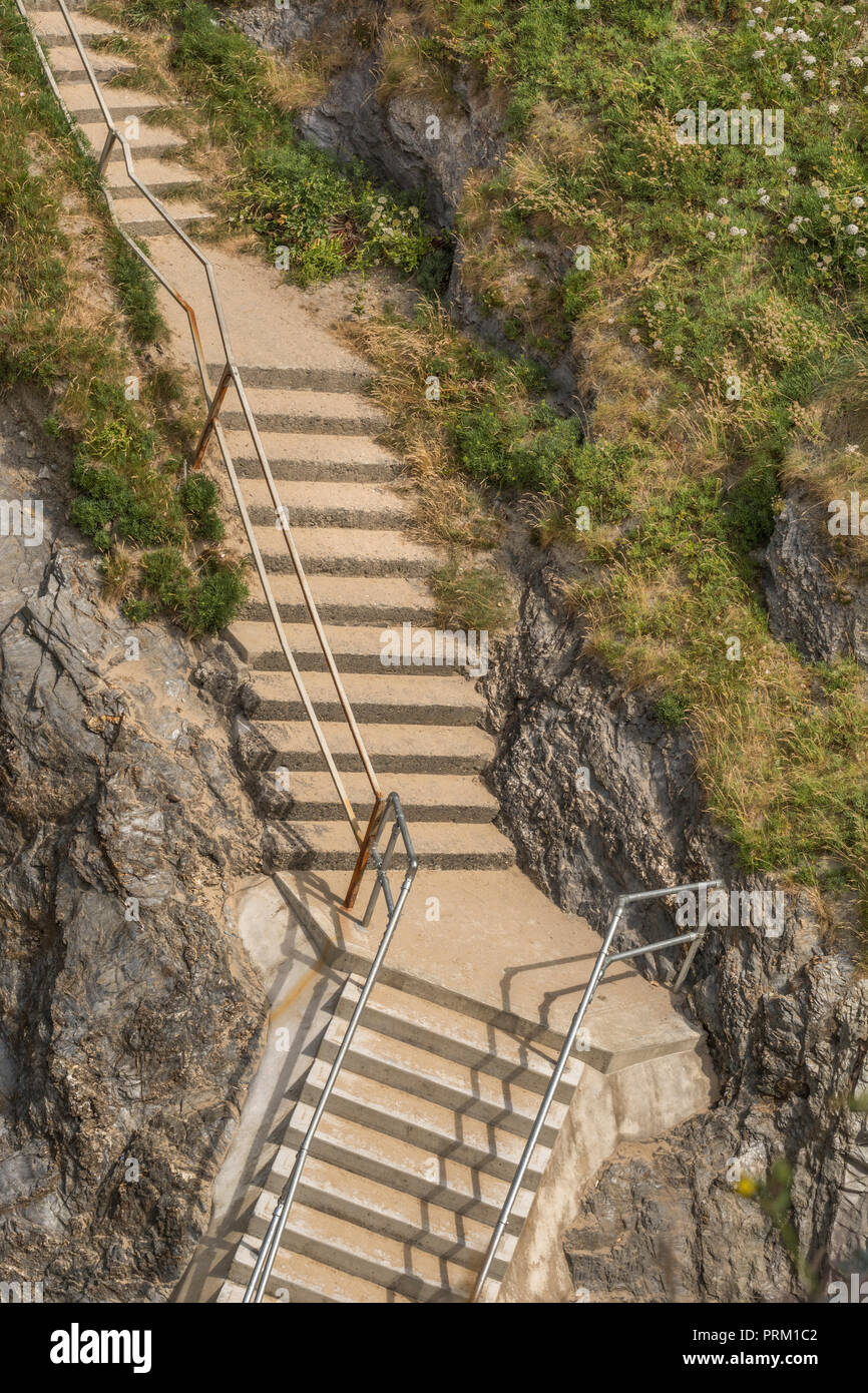 Steep steps leading to/from beach at Newquay, Cornwal .For climbing career ladder, corporate ladder. Also housing ladder / property ladder, long climb Stock Photo