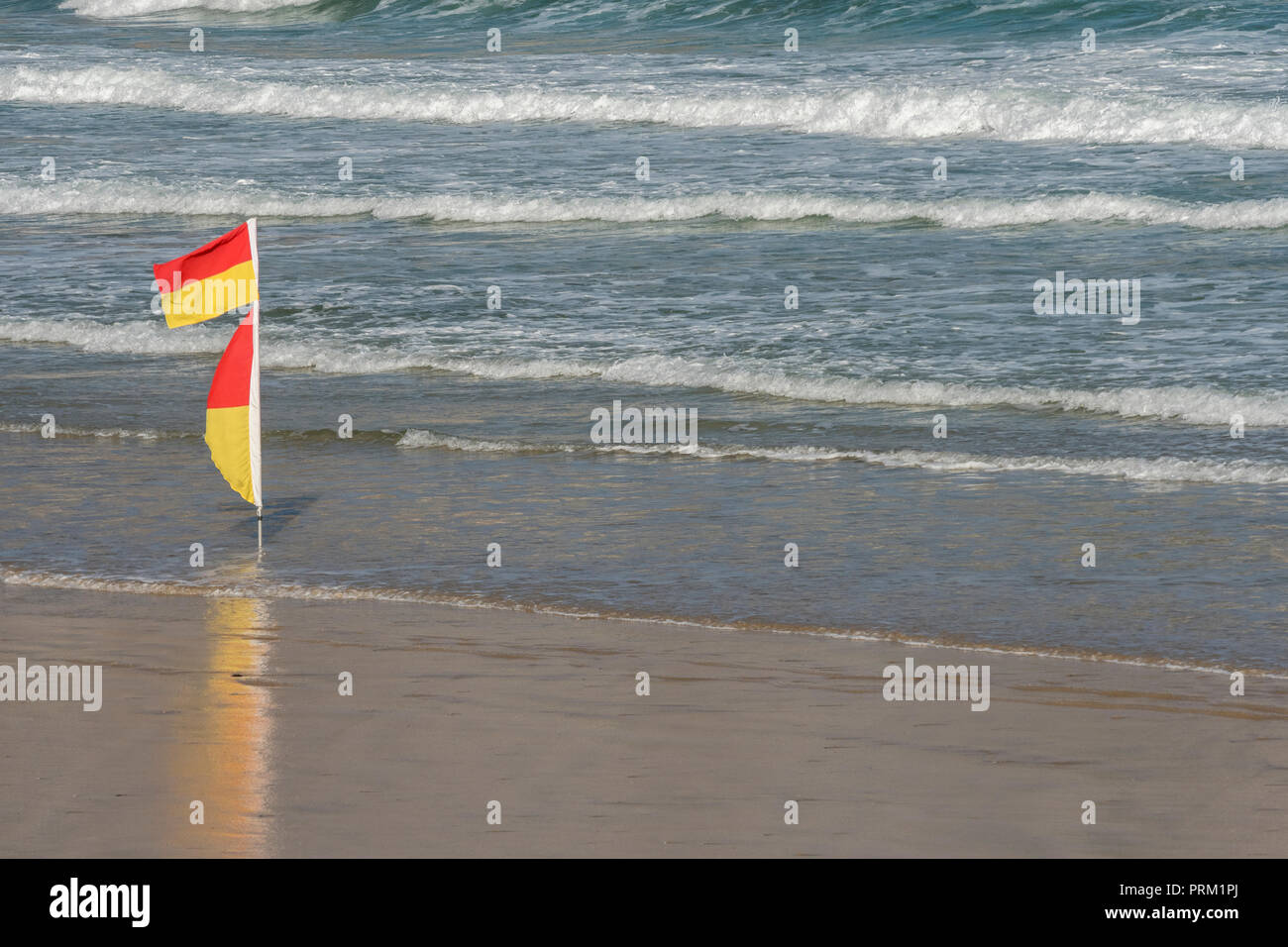 Bathing Flags – only swim between two Yellow and Orange flags. Seaside, beach safety warning flags. Stock Photo