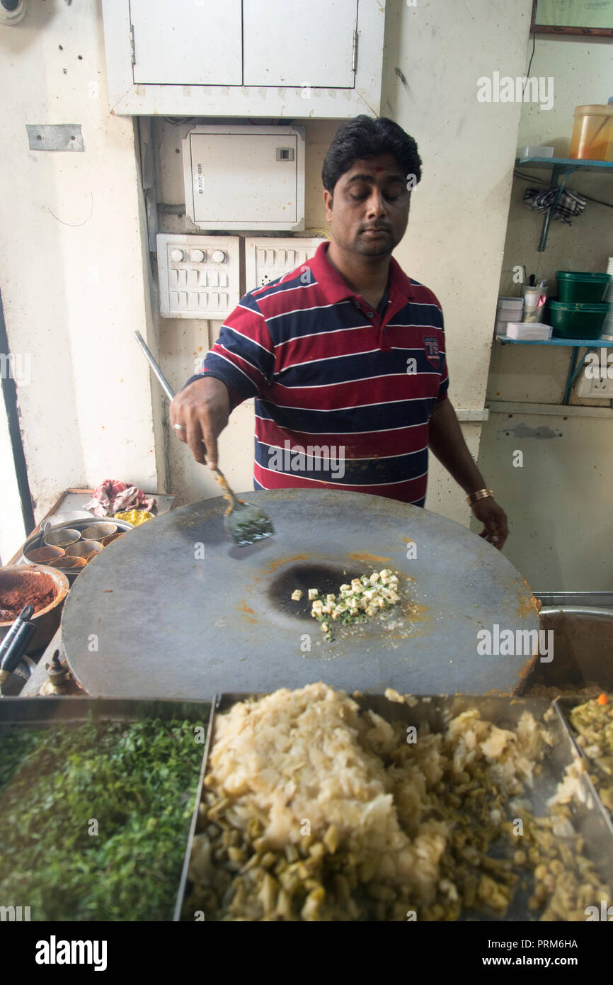 Preparing and selling Indian street food in a food stall. Photographed in Ahmedabad, Gujarat, India Stock Photo